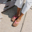 Reef Cushion Breeze pink slides facing forward on woman’s feet, showing soft-rebound cushioning and arch support.