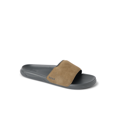 Tailslide men's slide sandal facing left with tan suede upper and cushioned black sole, surf-inspired comfort design.