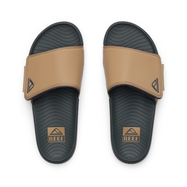Phantom Slab men's slides facing up, tan straps with REEF logo, cushioned footbed with arch support for beach comfort.