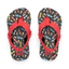 Little Ahi boys flip flops with red straps facing upward, featuring colorful bolt pattern, soft cushioning, and arch support.