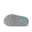 Little Totally Beachin boys sandal sole facing up, showing textured palm tree design and blue grip accents.