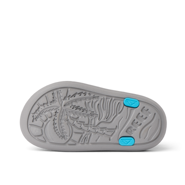 Little Totally Beachin boys sandal sole facing up, showing textured palm tree design and blue grip accents.