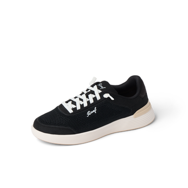 Shoreline Palisades women’s sneaker facing right with breathable black mesh upper and cushioned white sole for beach comfort