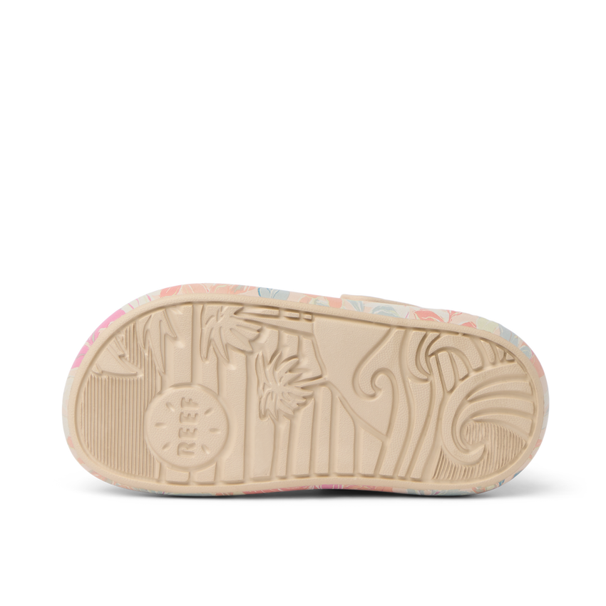 Little Rio Slide showing bottom sole facing up with embossed reef logo and surf-inspired patterns in apricot multi colors.