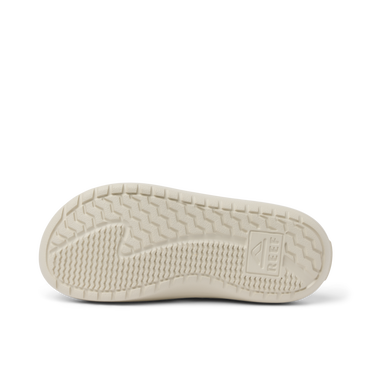 Glider outsole close-up, toe pointing left, with textured tread and molded arch support