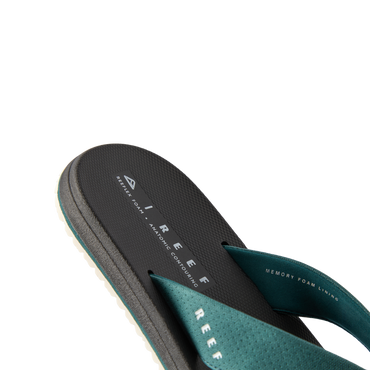 Nox men’s sandal facing left, close-up of the footbed and teal strap with memory foam for beach comfort.