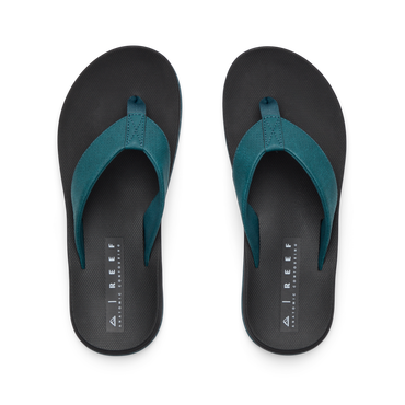 Top view of Nox men's flip flops in black with teal straps, featuring anatomical arch support and soft cushioning for all-day comfort.
