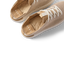 Reef Neptune women's shoes facing left with close-up on cushioned insoles and breathable knit upper in metallic gold.