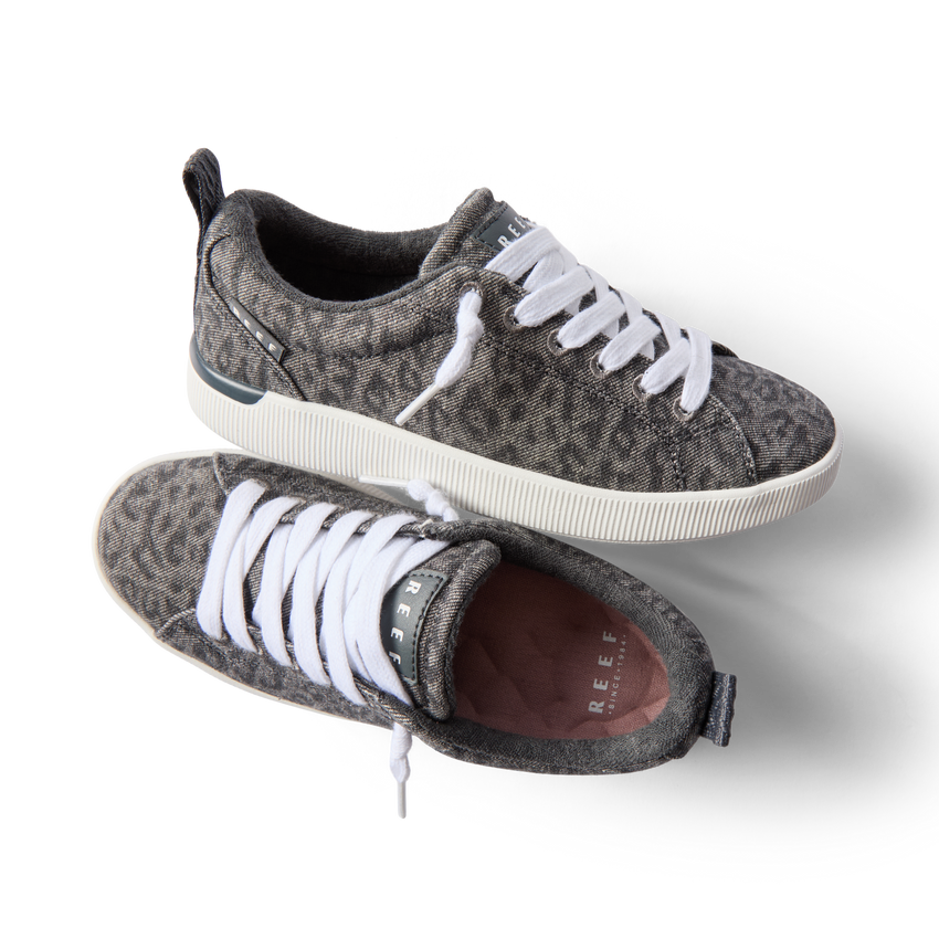 Pair of Neptune Alana women's sneakers with denim cheetah print, white laces, and anatomical arch support, top and side views.