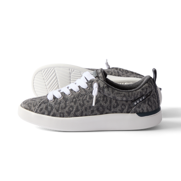 Neptune Alana women's sneaker facing right, leopard print fabric with white laces, featuring cushioned sole and arch support.