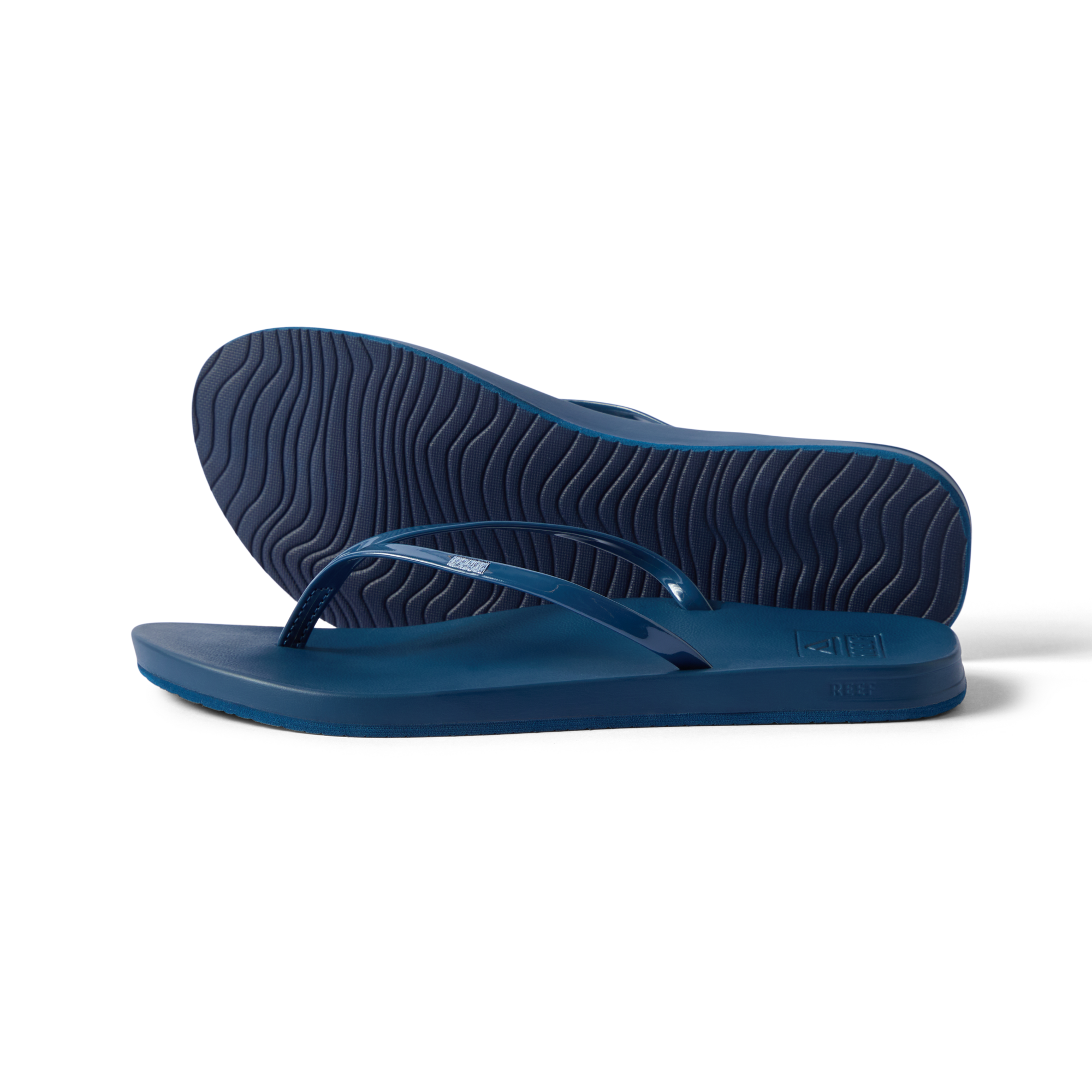 Cushion Slim navy flip flops facing left with top and sole view, water-friendly with anatomical arch support and cushioning.