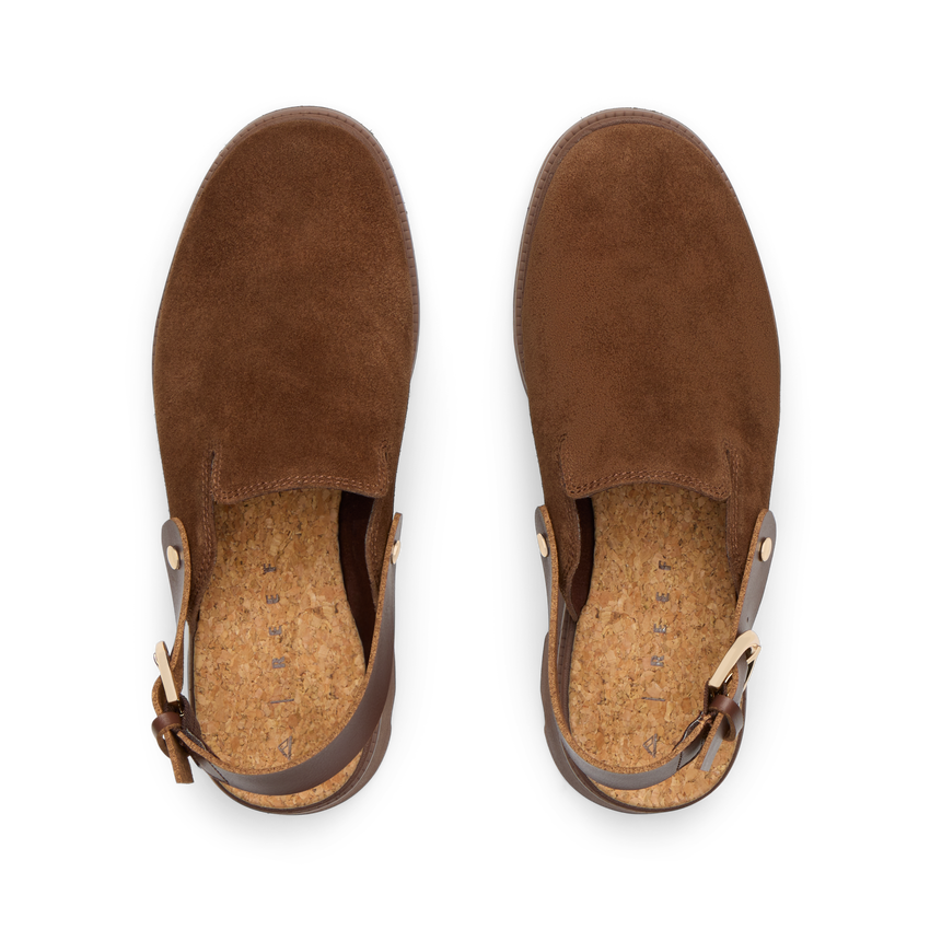 Top-down view of brown suede Vista Luxe Solene clogs facing upward, featuring adjustable buckle straps and cushioned footbeds.