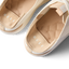 Close-up of the footbed and heel of Reef Neptune sandals in white champagne, highlighting comfort and arch support.
