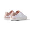 Reef Neptune women's white shoe with rose gold heel counter facing backward, showcasing cushioned, breathable design.