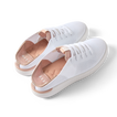 Reef Neptune women's white and rose gold sneakers angled side view showing lightweight knit upper and cushioned heel.