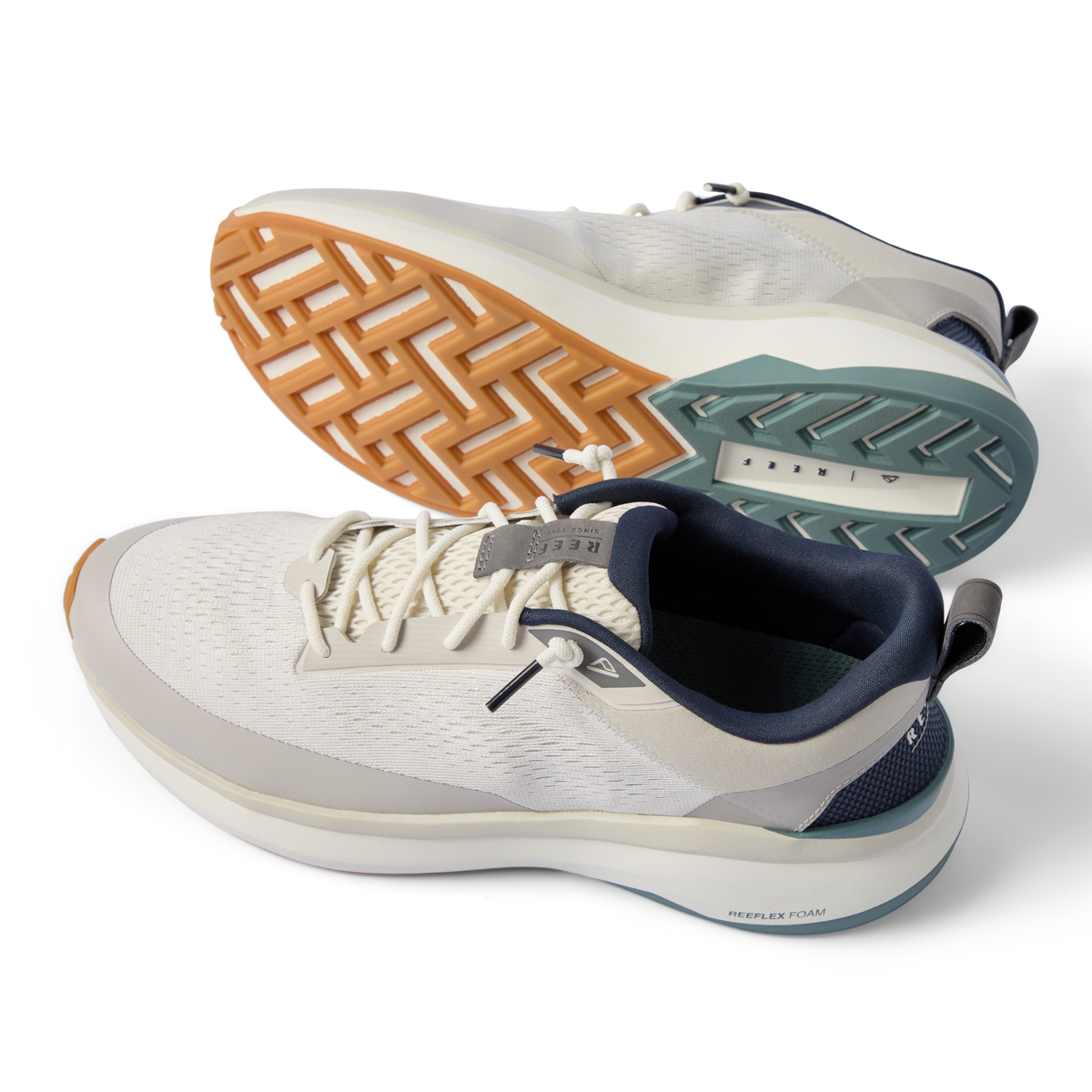 Zuma grey sneakers facing left, with breathable knit uppers, cushioned midsoles, and a textured outsole