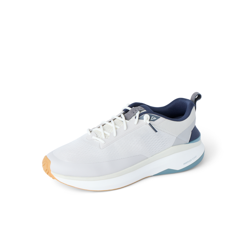 Reef Zuma white and gray sneaker facing left with a cushioned sole and flexible heel