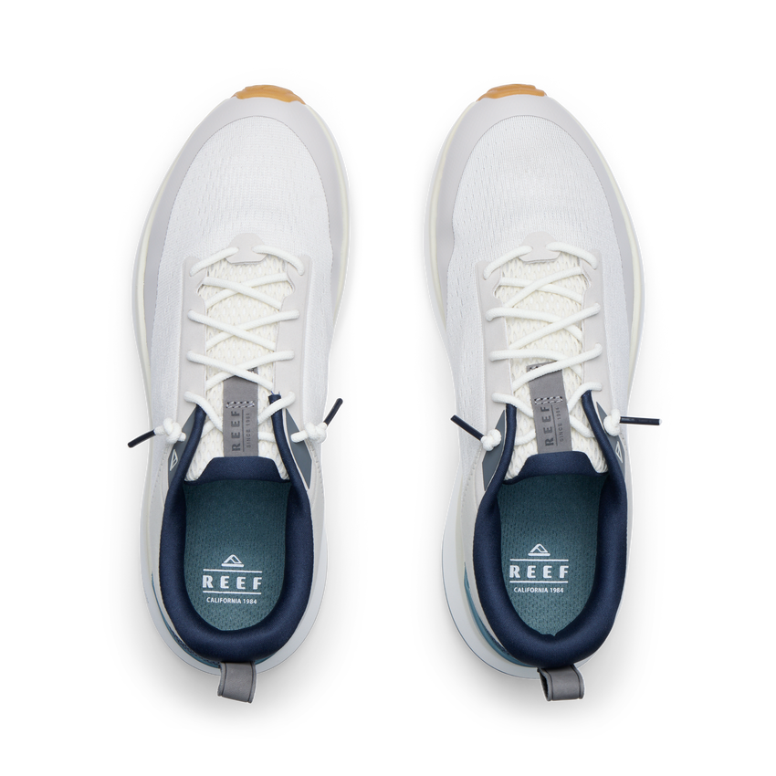 Reef Zuma white sneakers viewed from above with toes facing upward, breathable knit uppers, and cushioned comfort