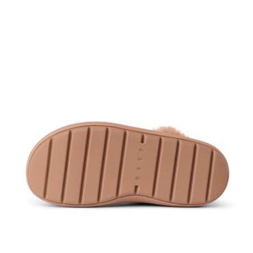 Close-up of a REEF sandal outsole facing up, showing durable, cushioned sole with textured grip lines.