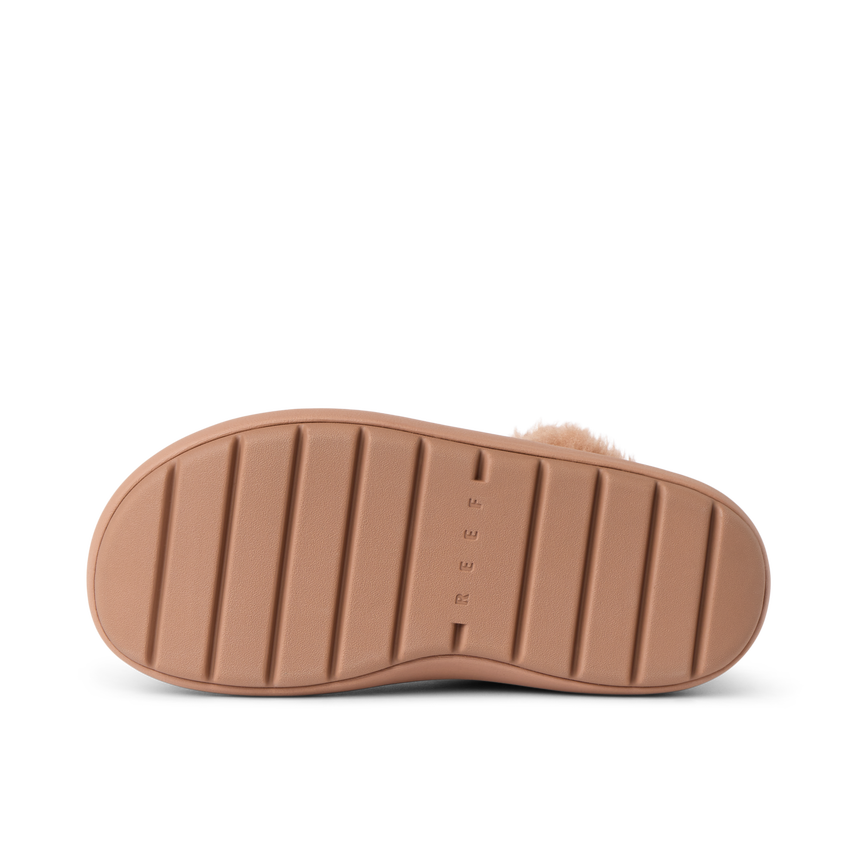 Close-up of a REEF sandal outsole facing up, showing durable, cushioned sole with textured grip lines.