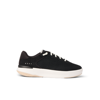 Side view of black Reef Del Mar sneaker with white sole, lightweight and cushioned for beach and everyday comfort.