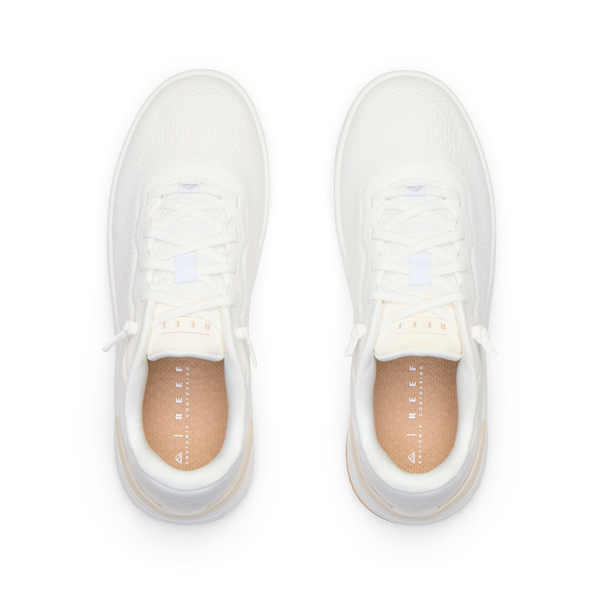 Top-down view of pair of white Reef Del Mar shoes featuring lightweight design and anatomical arch support for comfort.