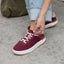 Reef Del Mar burgundy sneaker facing lower left with white laces and cushioned sole