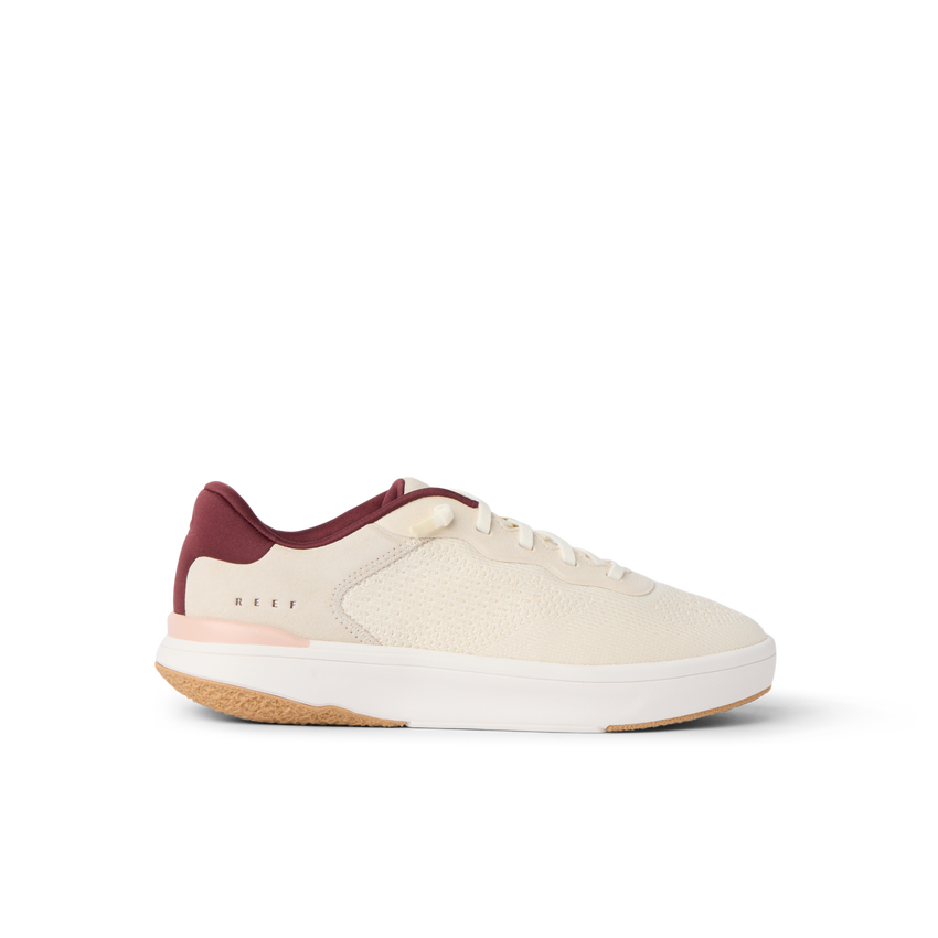 Reef Del Mar cream sneaker facing right with burgundy accents and cushioned sole for everyday comfort