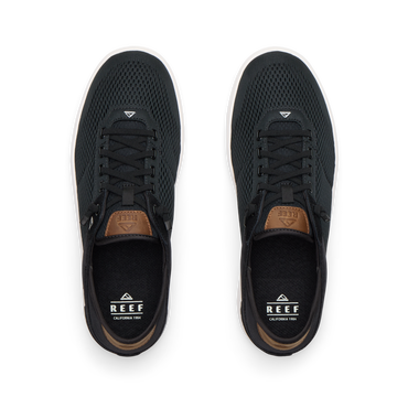 Top view of black Laguna sneakers with breathable mesh uppers, laces, and REEF branding for men’s and women’s shoes.