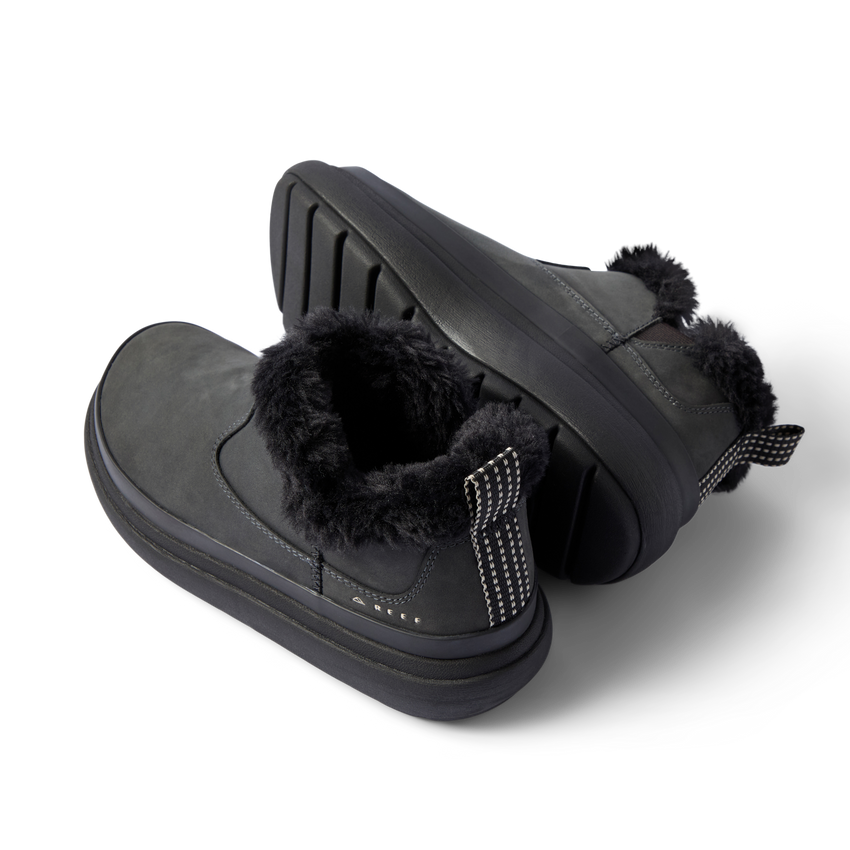 Pair of black Weekend Olivia boots, angled right, showing plush faux fur collar and durable grippy sole.