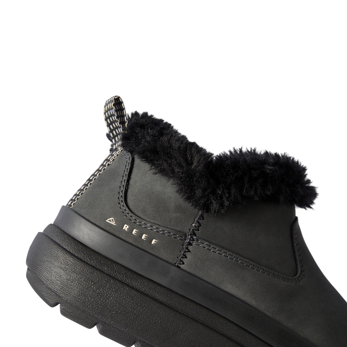 Close-up of the left side of the Weekend Olivia boot in black with plush lining, water-resistant nubuck, and REEF logo.