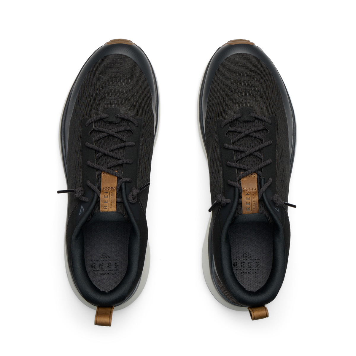 Reef Zuma black sneakers viewed from above, facing upward, with breathable knit uppers and cushioned heel tabs