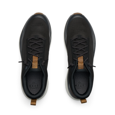 Reef Zuma black sneakers viewed from above, facing upward, with breathable knit uppers and cushioned heel tabs