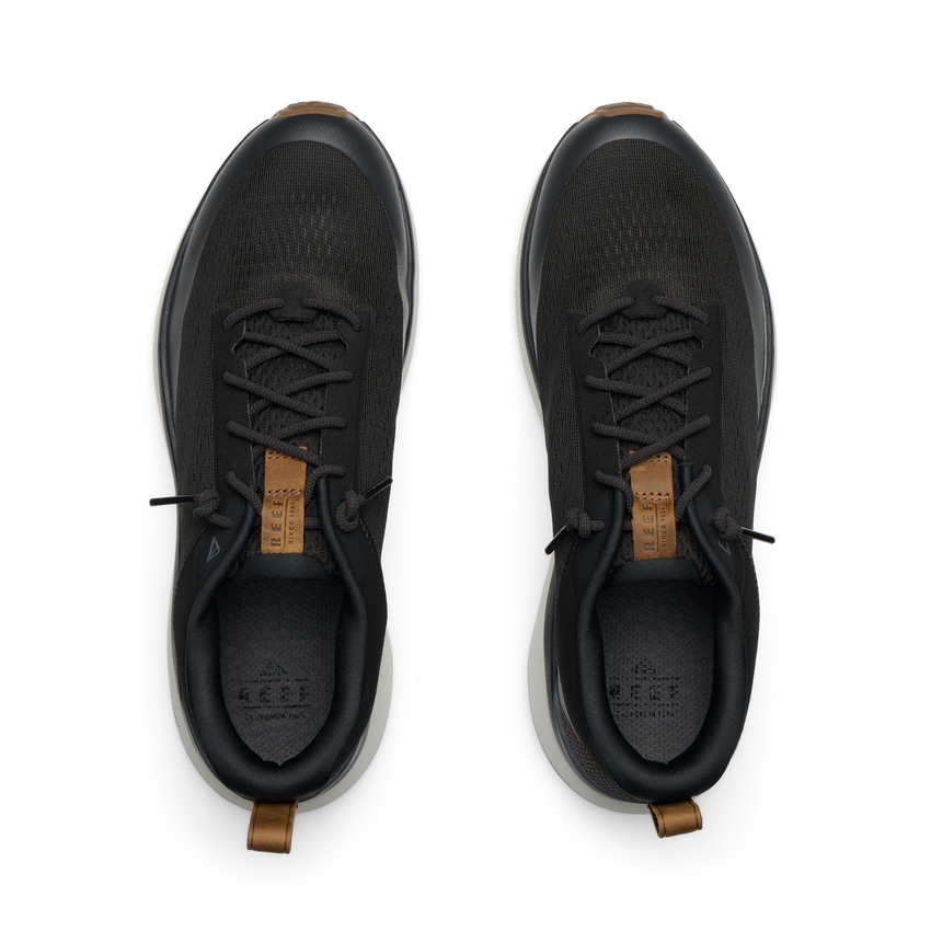 Reef Zuma black sneakers viewed from above, facing upward, with breathable knit uppers and cushioned heel tabs