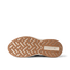 Reef Zuma sneaker close-up, outsole facing up with toe pointing left and heel right, showing textured tread and cushioned sole