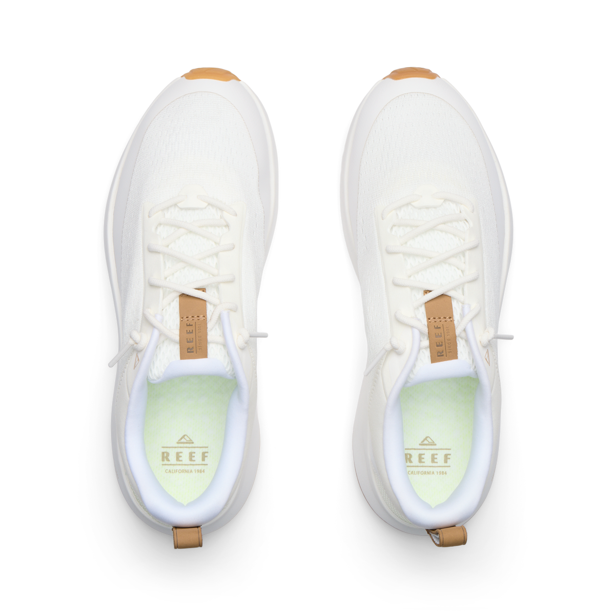 Reef Zuma white sneakers facing forward from a top view with breathable knit uppers and cushioned footbeds