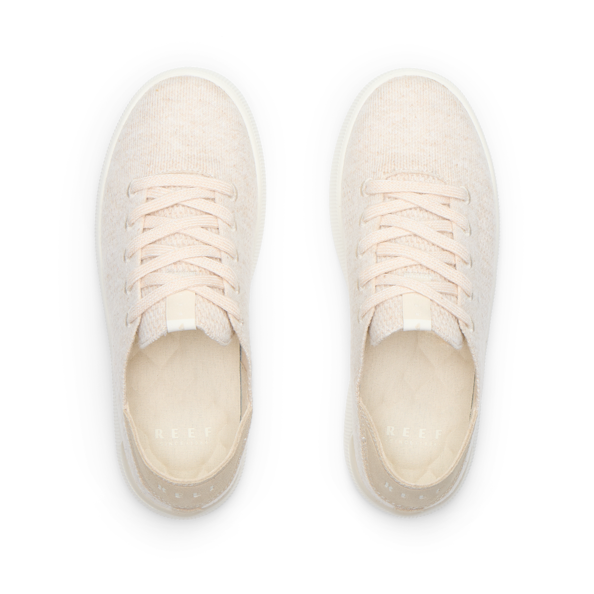 Pair of cream lace-up sneakers viewed from above, both facing upward with toes away and heels toward the viewer