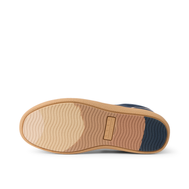 REEF Kickback sneaker outsole close up facing left with wave tread and cushioned support