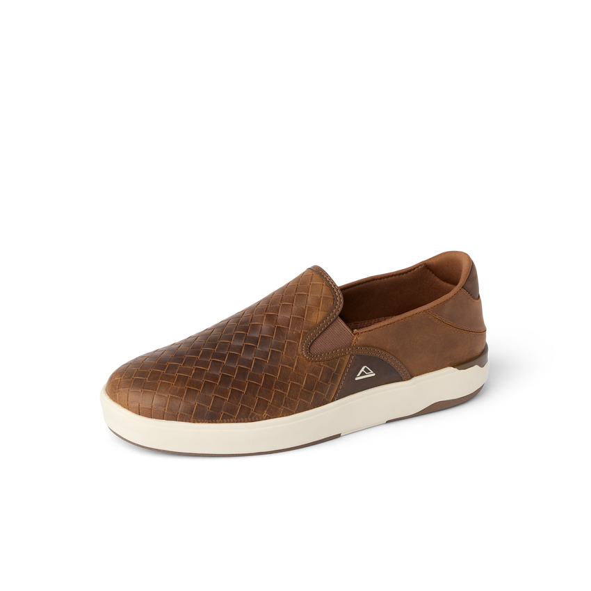 Laguna Slip On brown slip-on shoe facing left with woven upper, cushioned sole, and fold-down heel