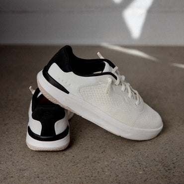 Reef Del Mar white sneakers, one facing right and another showing the heel, with lightweight cushioned comfort