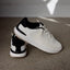 Reef Del Mar white sneakers, one facing right and another showing the heel, with lightweight cushioned comfort