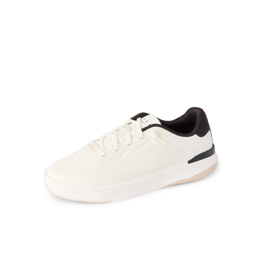 Reef Del Mar white sneaker facing left in side view with a cushioned sole and comfort focused design