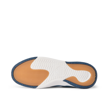 Del Mar Slip On close-up from below, toe facing left, showing orange traction tread and white cushioned sole