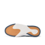 Del Mar Slip On close-up from below, toe facing left, showing orange traction tread and white cushioned sole