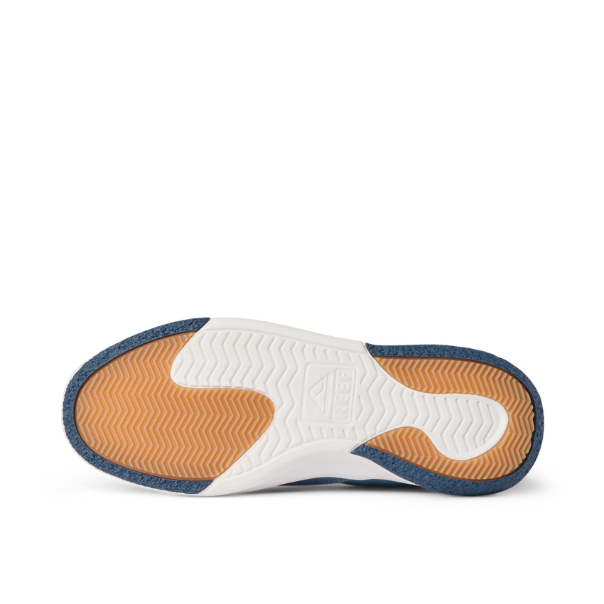 Del Mar Slip On close-up from below, toe facing left, showing orange traction tread and white cushioned sole