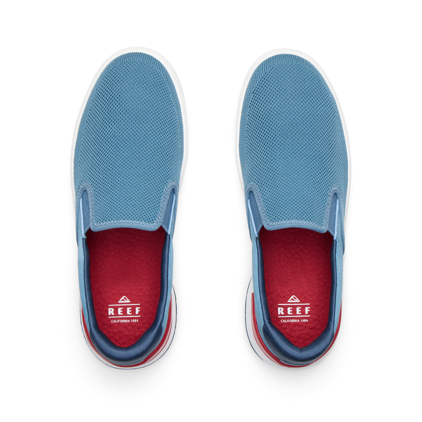 Del Mar Slip On blue slip on sneakers viewed from above with toes facing upward and cushioned footbeds visible