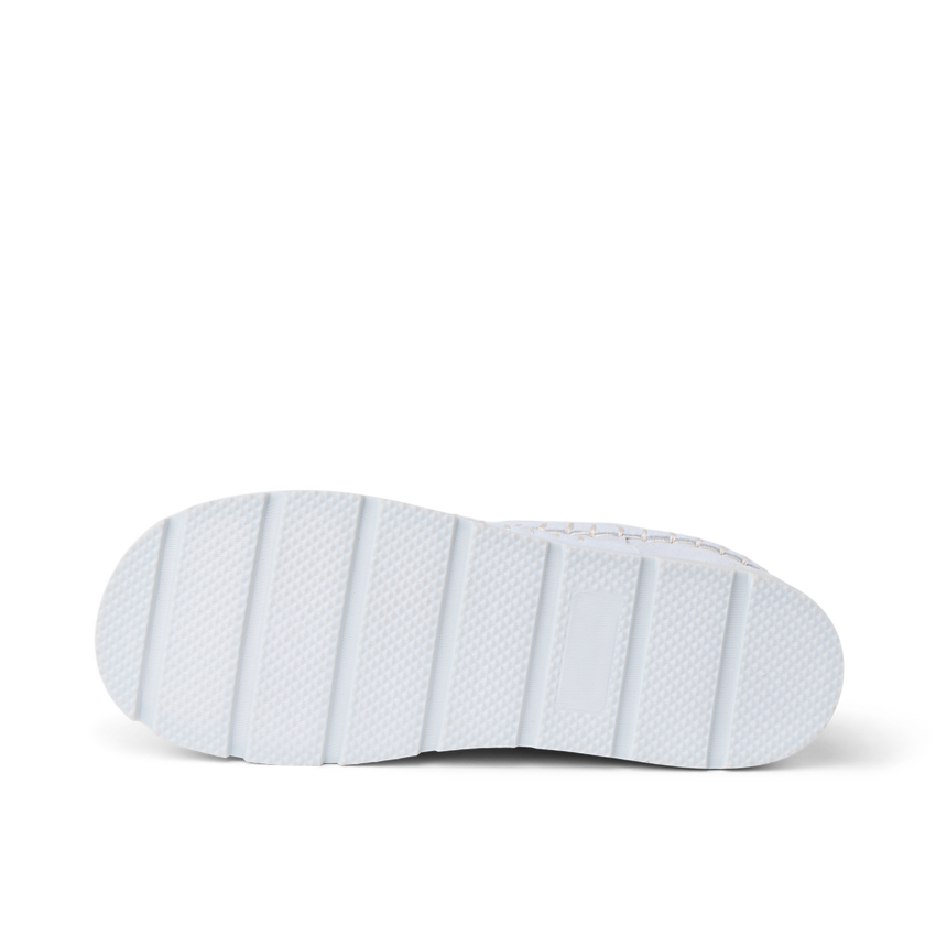 Noa Slipper outsole close up facing right with textured white tread and deep traction grooves