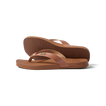 Vista Lune women's tan flip flops facing right, close-up on sole and strap, beach-inspired comfort and arch support sandals.