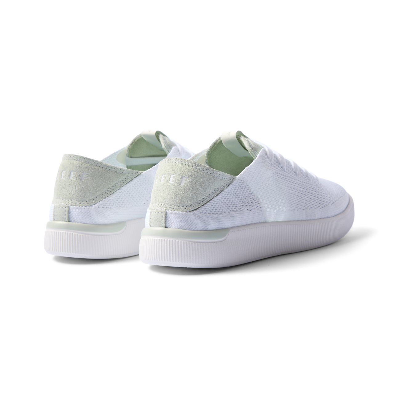 Reef Neptune women's sneakers showing rear and lateral sides facing left in white and dusty sage with cushioned arch support.