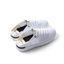Reef Neptune women's white and black sneakers facing left, featuring breathable knit upper and cushioned sole for all-day comfort.